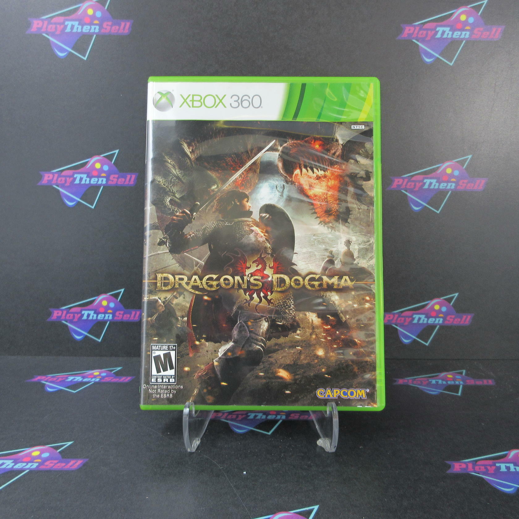 A used Xbox 360 game disc for the game Dragon's Dogma, with a green Xbox 360 console in the background. The game cover features an illustration of a character in armor riding a dragon.